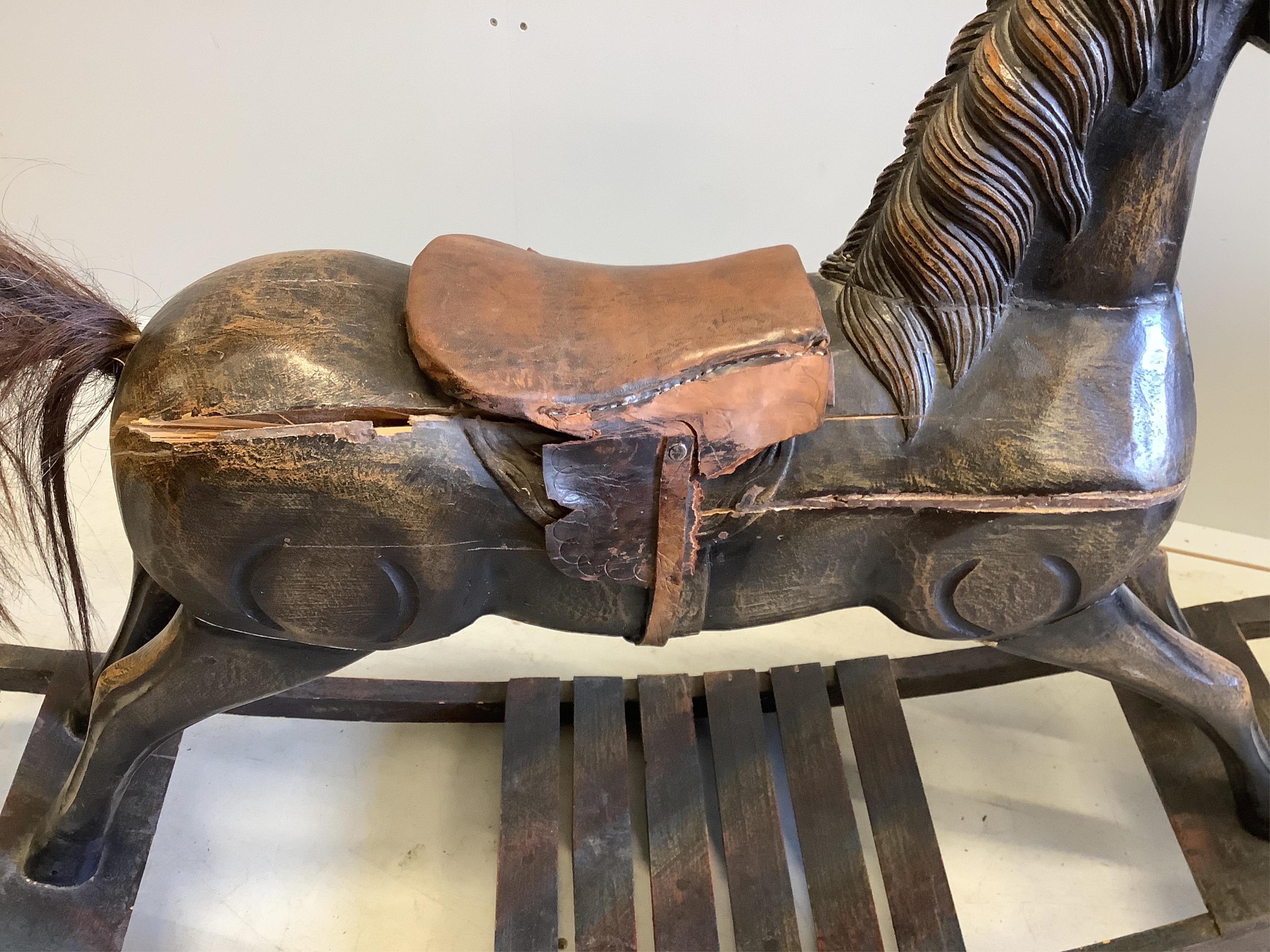 A French 19th century style child’s carved wood rocking horse, length 118cm, height 82cm. Condition - poor